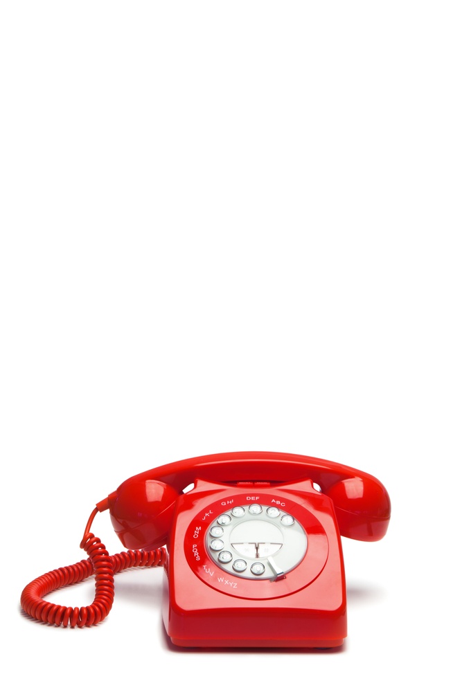 Antique red phone on a white background